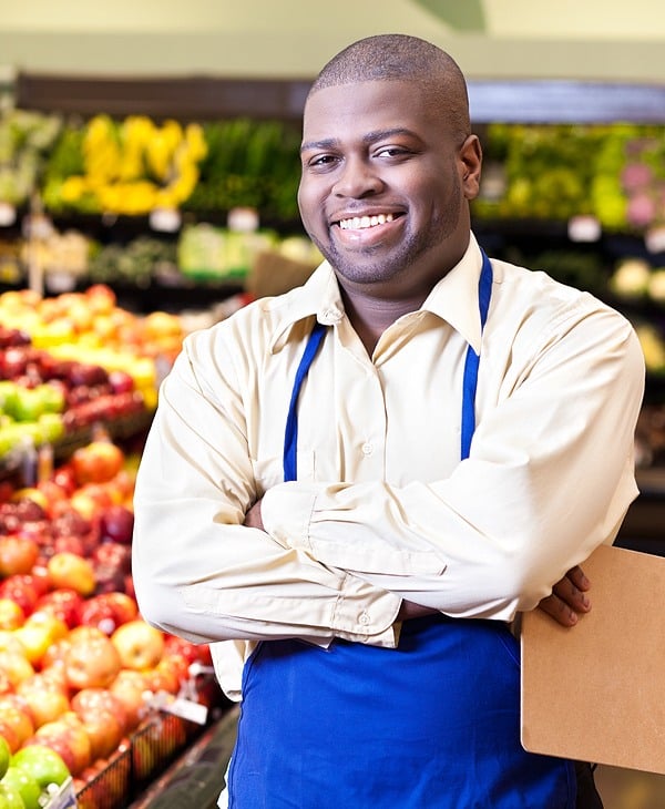 business owner standing in his grocery store