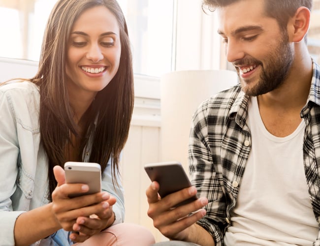 couple looking at mobile banking apps on their phones