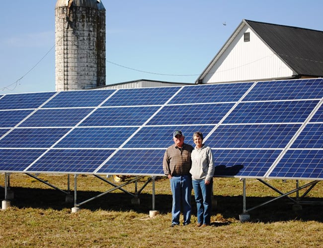 NCB customers standing in front of their solar panels